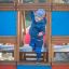 Child playing on a Small Ship sandbox structure.