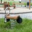 Bike rocking in a playground with spring base on grass.