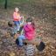 Children enjoying the Bike rocking in a park during autumn.