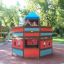 Children playing in a multicolored Ship sandbox in a park.
