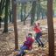 Children playing on Nature Double Swing in autumn park