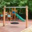 Single Swing - wooden playground structure with various swings on a sandy surface