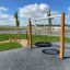 Single Swing playground equipment with tire seat in a park setting