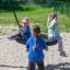 Children playing on the Single Swing in a playground.