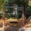 Single Swing in a playground surrounded by autumn leaves