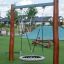 Single Swing outdoor playground equipment with wooden posts and a net seat.