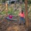 Children playing on a Single Swing in an autumn park.