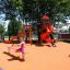 Red playground equipment with slides and seesaws.