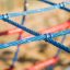 Close-up of Starfish steel structure's blue and red climbing ropes.