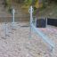 Starfish steel structure climbing playground equipment in gravel area.