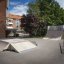 Quarter-Pipe high and other skateboarding ramps in a residential area.
