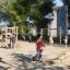 Children playing on a Ramp Eco playground structure in a park.