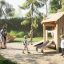Children playing on Tambora Eco wooden playground equipment in a park.