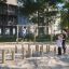 Children playing on the Ural Eco playground equipment in a sunny residential area.