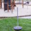 Playground Spinner III on grassy area with climbing structures in the background