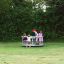 Children playing on the Merry-Go-Round in a park.