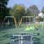 Merry-Go-Round in a children’s playground equipped with swings and other play structures.'
