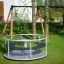 Playground Merry-Go-Round surrounded by trees and grass.