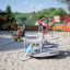Children playing on the Merry-Go-Round in a playground.