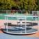 Merry-Go-Round playground equipment in a sunny park setting.