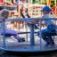 Children playing on a Merry-Go-Round playground equipment.