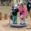 Children playing on the Bee playground equipment.