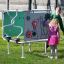 Children playing with Sensory Box playground equipment featuring interactive gears and light bulb il