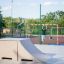 Children playing on Combination 6 playground equipment in a sports area.