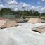 Skatepark ramps and obstacles on a sunny day.