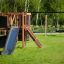 Climbing Kiosk Nature with slide and swing set in a grassy park
