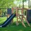 Outdoor wooden play structure with slide and climbing elements, Climbing Kiosk Nature.