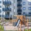 Climbing Kiosk Nature playground set with slide and climbing structure in residential area.