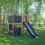 Climbing Kiosk Nature playground structure with slide and climbing elements in a park.