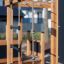 Outdoor Climbing Kiosk Nature wooden structure with ropes and ladder.