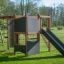 Outdoor playground climbing structure Climbing Kiosk Nature with slide and climbing walls on a grass