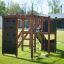 Outdoor playground structure Climbing Kiosk Nature on a green lawn.