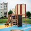 Children playing on Climbing Kiosk Nature playground set in an urban area.