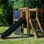 Wooden outdoor play structure with slide and climbing nets - Climbing Kiosk Nature.