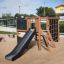 Children's playground set with a slide, climbing wall, and rope ladder - Climbing Kiosk Nature.