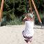 Child enjoying the Medium Cableway at a playground on a sunny day.