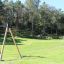 Medium Cableway for playgrounds in a park with wooden and metal supports.