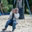 Silver Cableway playground equipment with child sliding on zip line seat