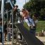 Children playing on the Silver Cableway at an outdoor playground.