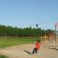 Child riding the Silver Cableway in a playground.