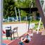 Child enjoying a ride on the Silver Cableway playground equipment.