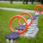 Double Seesaw in a playground with red handles and spring base.