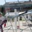 Girl climbing on Powerclimber climbing net in a playground.