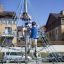 Children climbing on a Powerclimber climbing net in a playground.