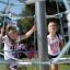 Children playing on a Powerclimber climbing net outdoors.