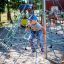 Child climbing on Powerclimber climbing net in playground.